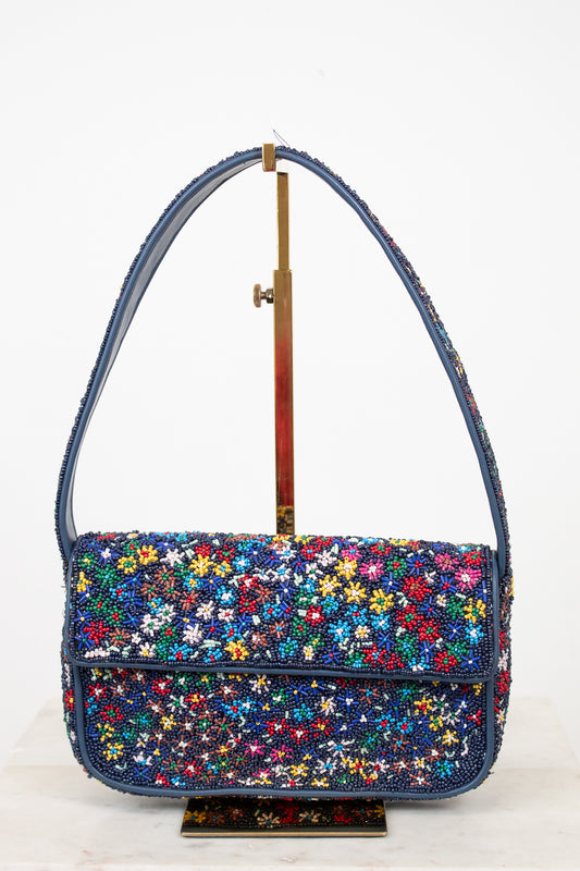 Multicolored floral-patterned beaded handbag on a white background