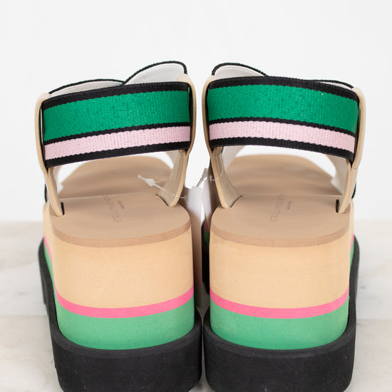 Colorful platform sandals with striped straps on a white background
