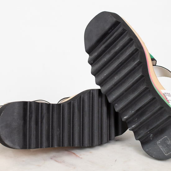 Close-up of a black rubber sole on a shoe with a white background