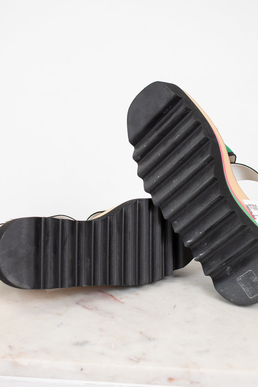 Close-up of a black rubber sole on a shoe with a white background