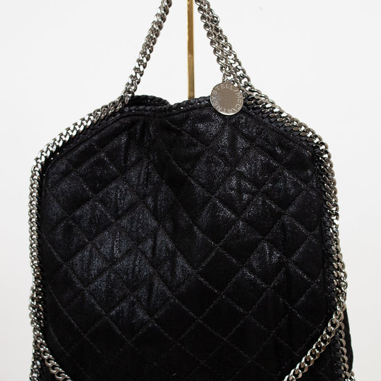 Black quilted handbag with chain details on a white background
