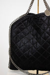 Black quilted handbag with chain strap on a white background
