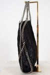 Black textured handbag with silver chain strap on a white background