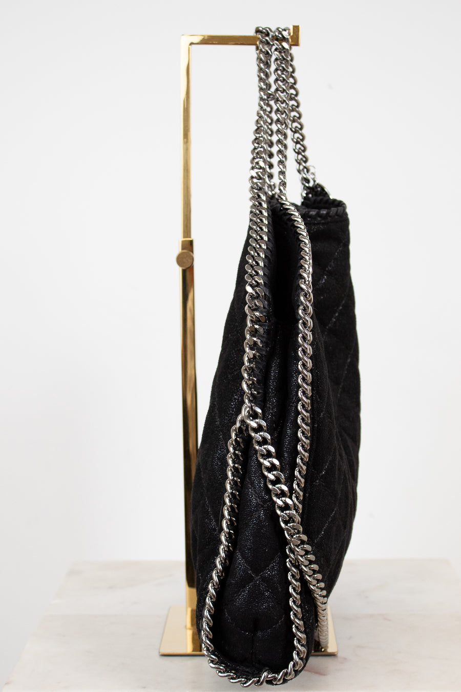 Black handbag with silver chain detail on a white background