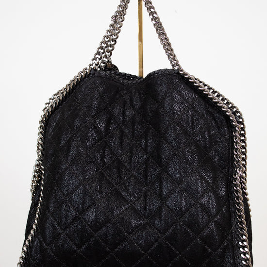 Black quilted handbag with chain details on a white background