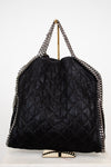 Black quilted handbag with chain details on a white background