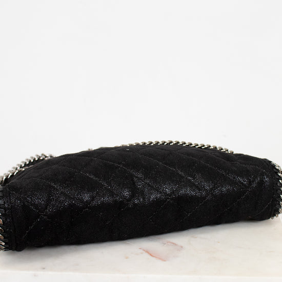 Black quilted bottom of bag on a white marble surface
