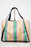 Striped handbag with 'Stella McCartney' branding on a white background