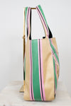 Beige tote bag with green and pink stripes on a white background