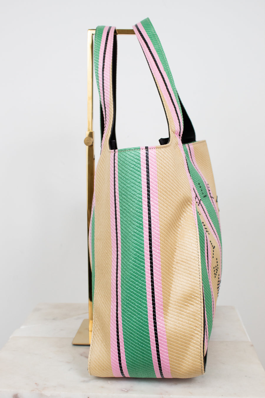 Beige tote bag with green and pink stripes on a white background