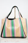 Striped handbag with green, pink, and beige colors on a white background