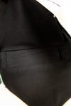 Close-up of a black interior of bag on a white background