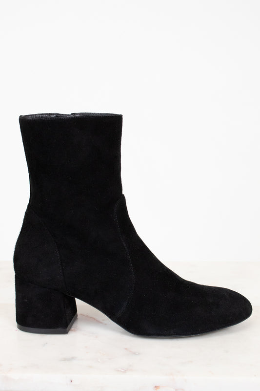 Black ankle boots on a white background