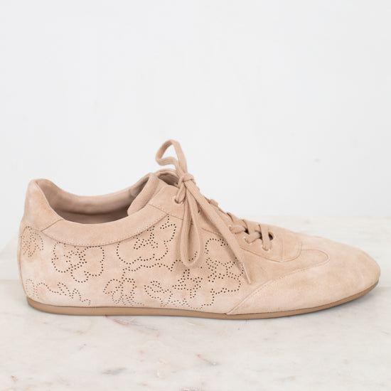 Beige sneaker with floral lace design on a light background