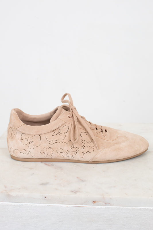 Beige sneaker with floral lace design on a light background