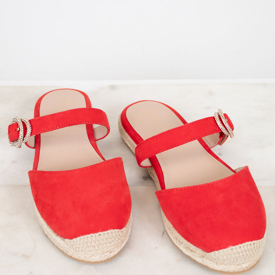 Red espadrille sandals on a light background
