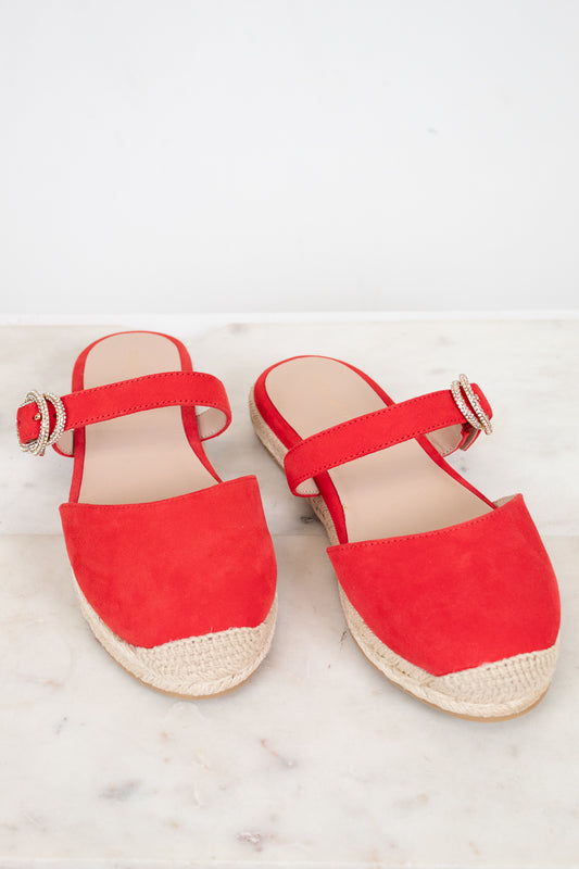 Red espadrille sandals on a light background