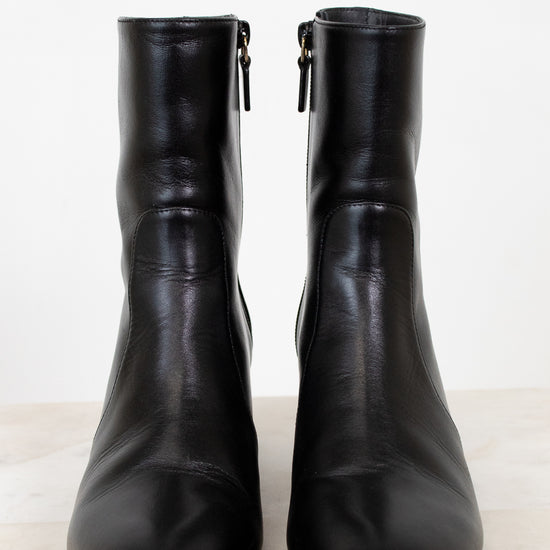 Pair of black leather boots on a white background