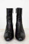 Pair of black leather boots on a white background