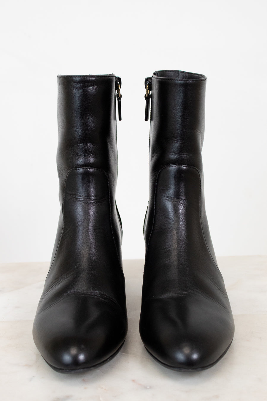 Pair of black leather boots on a white background