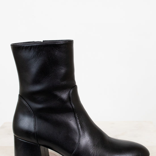 Black ankle boot on a light gray background