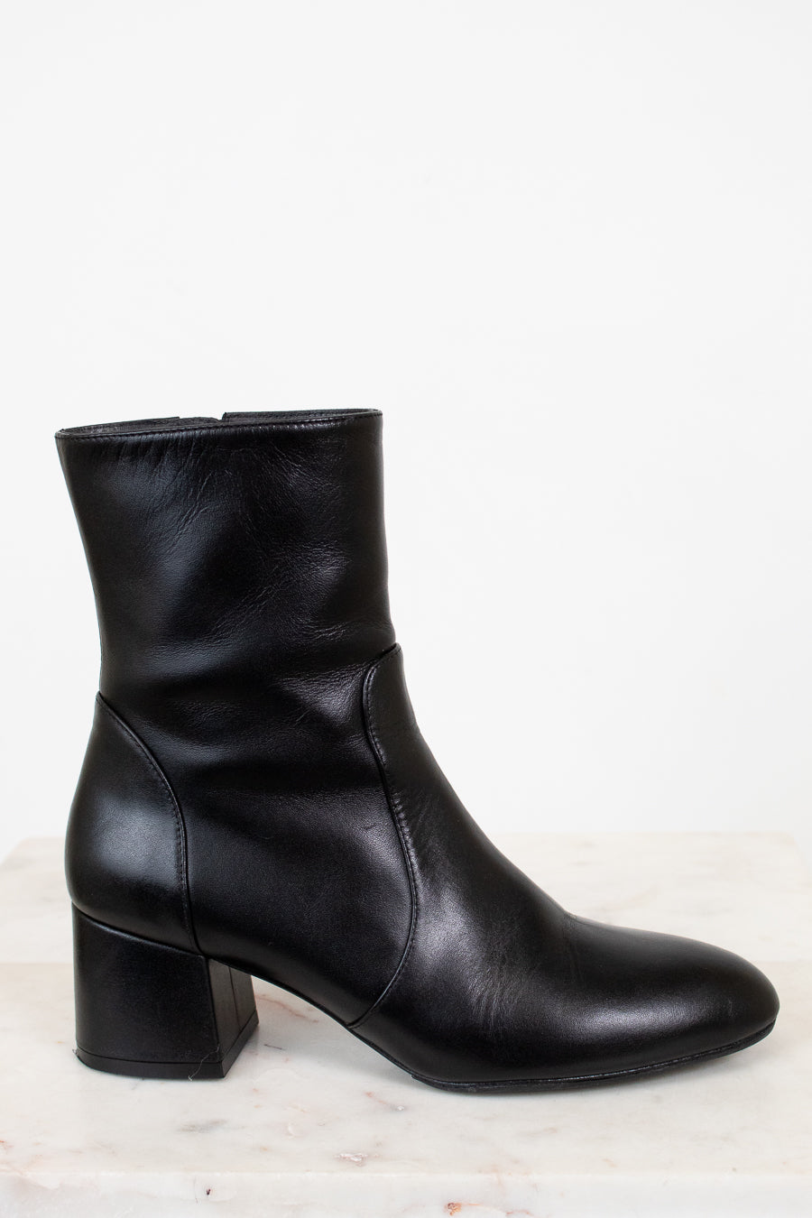 Black ankle boot on a light gray background