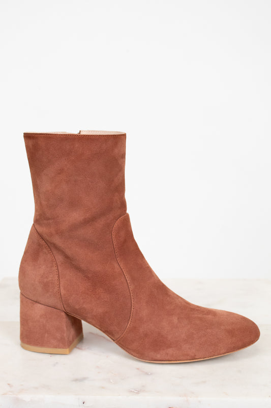 Brown suede boot on a white background