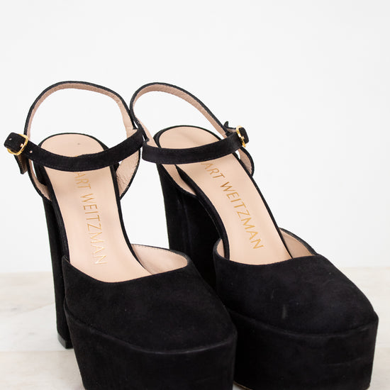 Black platform sandals on a white background