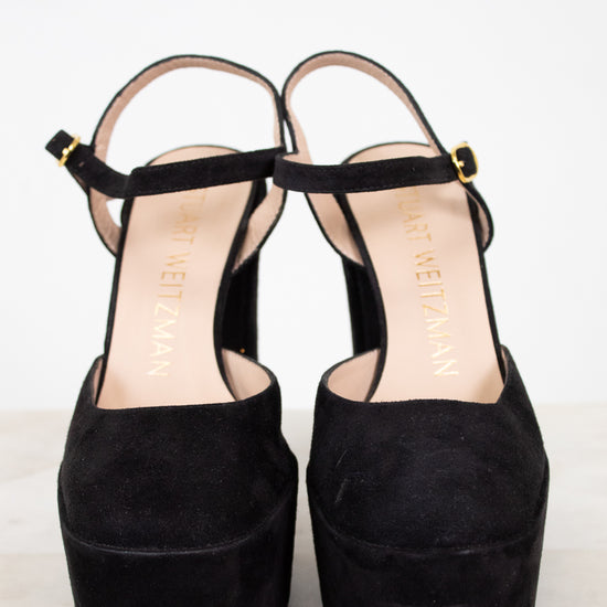 Black platform sandals on a white background