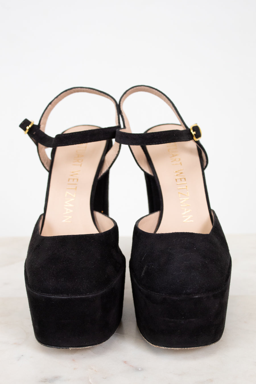 Black platform sandals on a white background