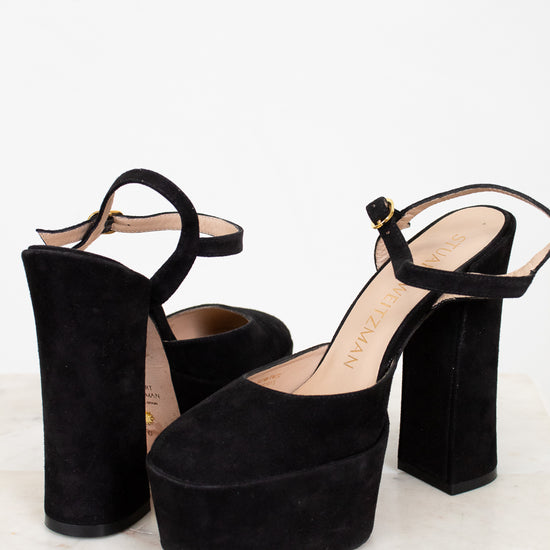 Black platform high heels on a white background