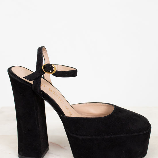 Side profile of black platform high-heeled shoe on a white background