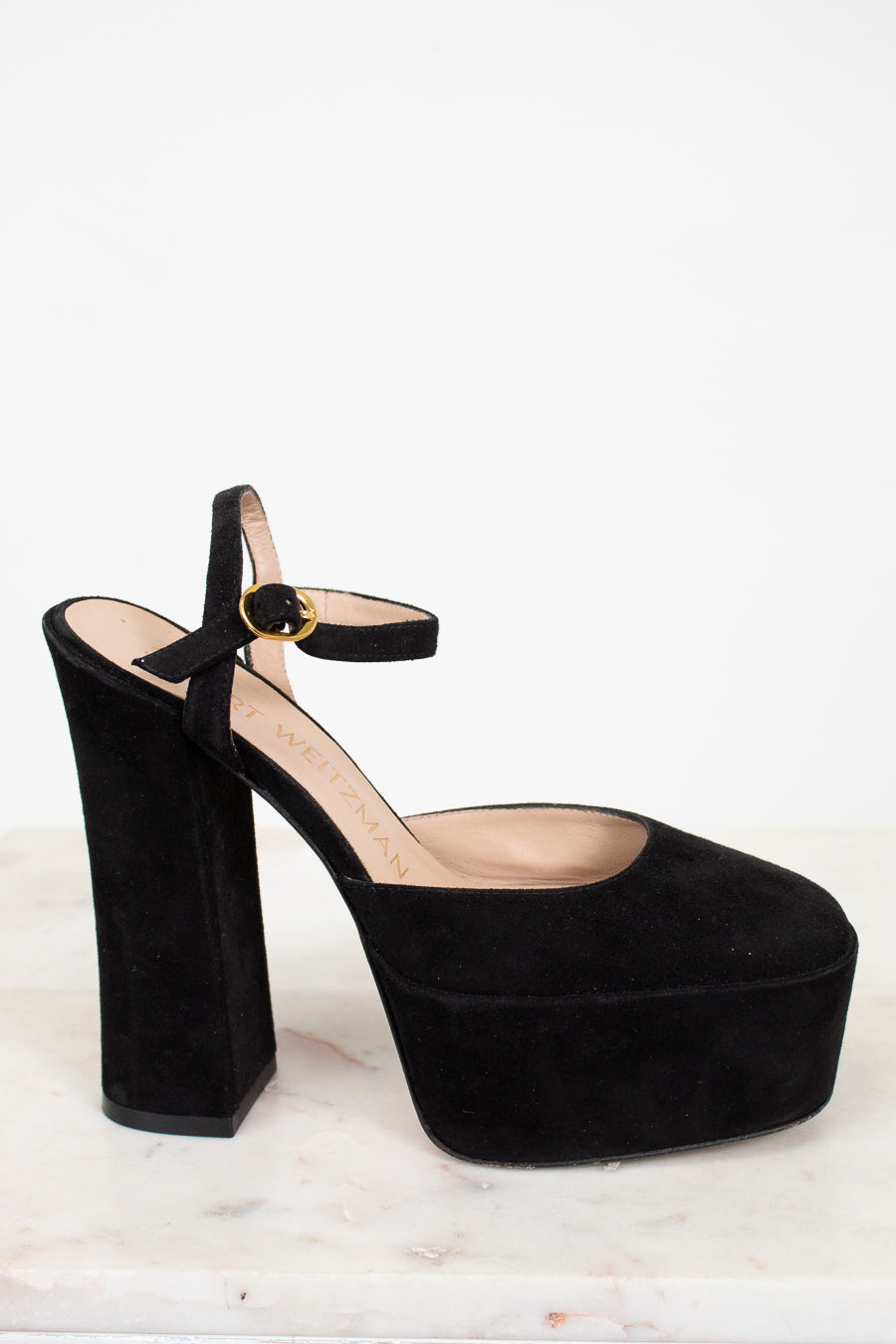 Side profile of black platform high-heeled shoe on a white background