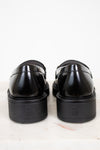 Pair of black loafers on a white background