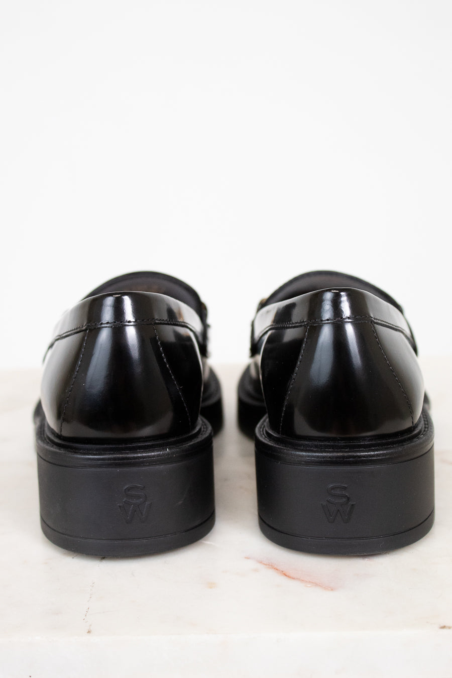 Pair of black loafers on a white background