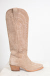 A single knee-high western boot in light tan suede with white embroidered stitching, shown in profile against a plain white background.