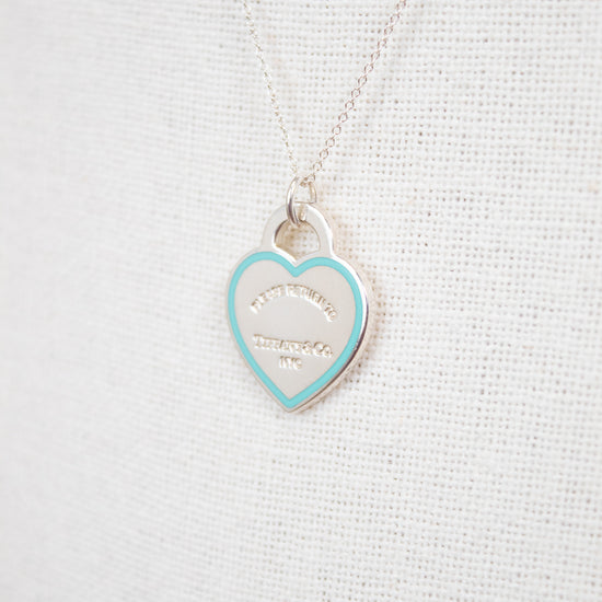 Heart-shaped pendant against white textured background