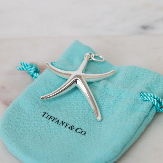 Silver starfish pendant on a Tiffany & Co. branded pouch.