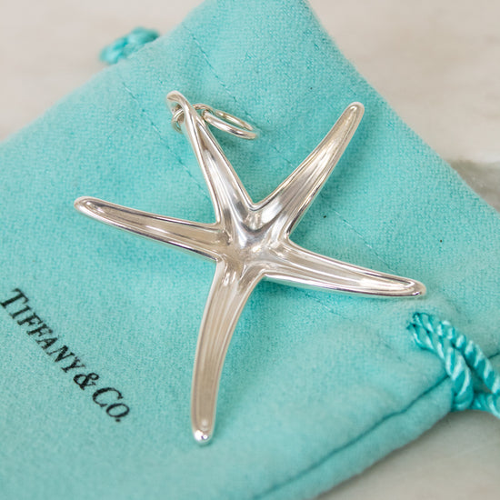 Silver starfish pendant on a Tiffany & Co. branded turquoise pouch
