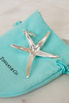 Silver starfish pendant on a Tiffany & Co. branded turquoise pouch