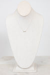 Infinity symbol necklace on white mannequin bust