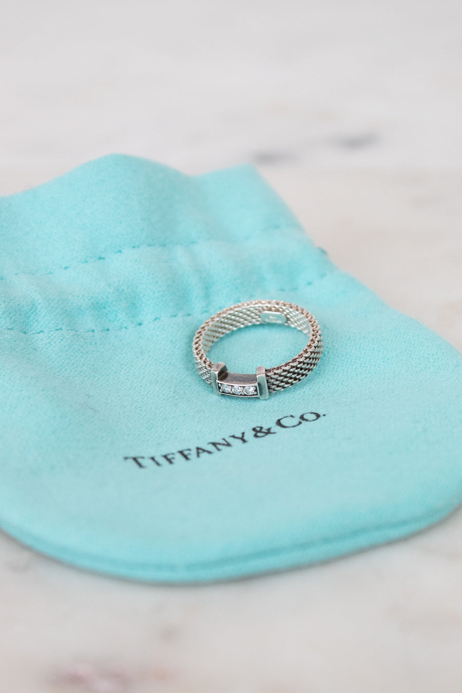 Silver ring on a Tiffany & Co blue pillow