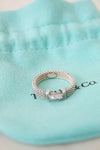 Silver ring with a diamond on a Tiffany & Co. box