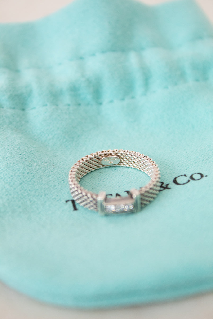 Silver ring with a diamond on a Tiffany & Co. box