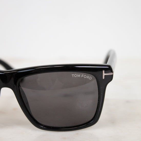 Black Tom Ford sunglasses on a light gray background