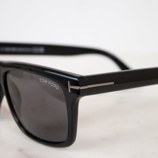 Black Tom Ford sunglasses on a light background