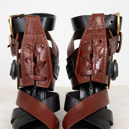 Pair of black and brown leather ankle supports on a white background