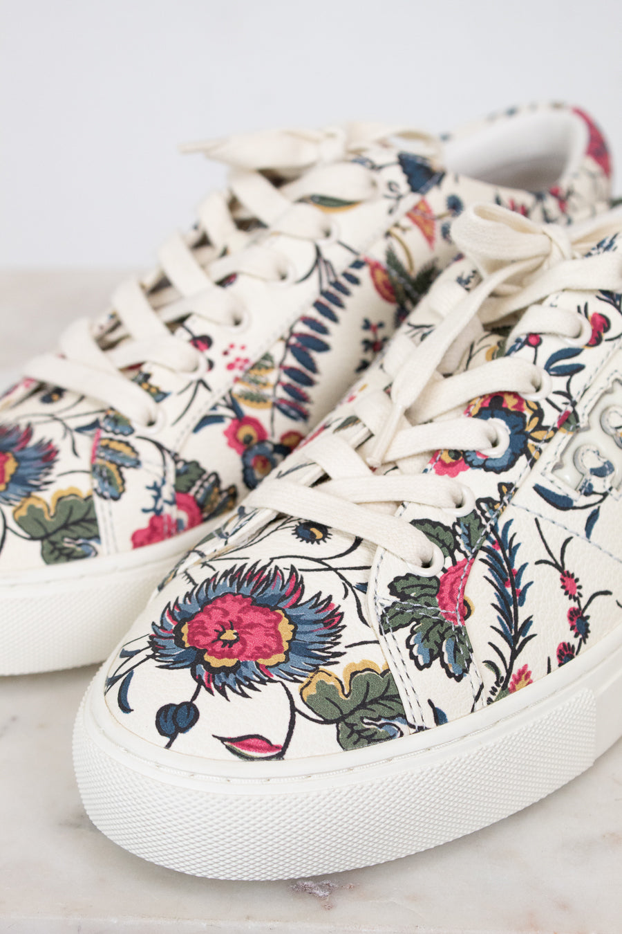 Floral patterned sneakers on a light background