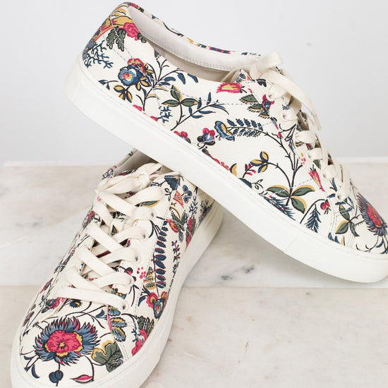 Pair of floral-patterned sneakers on a light background