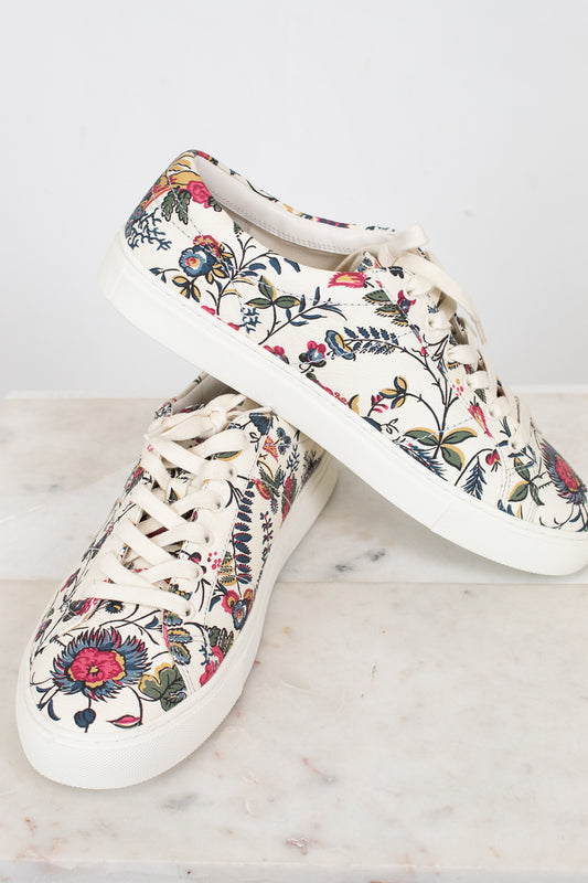 Pair of floral-patterned sneakers on a light background